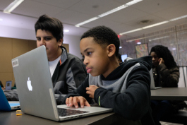Justin Martin, 12, works on coding a video game at the TigerCrew program, hosted by nonprofit CodeCrew. (Brandon Dahlberg)