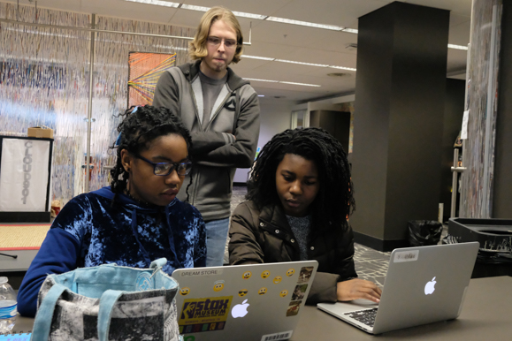 Ariel Thompson, 13, and Christian WIlliams, 17, work on their code while Alex Ziegenhorn looks on at the TigerCrew program hosted by CodeCrew. (Brandon Dahlberg)