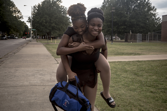 Asya Miles gets a lift to get around from Precious Price after hurting her ankle during ballet practice. (Andrea Morales)