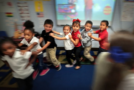 Yvonne Thomas' kindergarteners dance to a song about fruit  in one of Treadwell Elementary School's dual language classes on September 21, 2018. Treadwell's dual language program immerses kids in both Spanish and English for full fluency by fifth gra