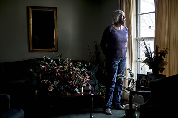 Mary Hill, 82, stands for a portrait at her home in Smokey City. She used to work at the Sears-Roebuck building as a waitress and has watched the neighborhood change over the years. 