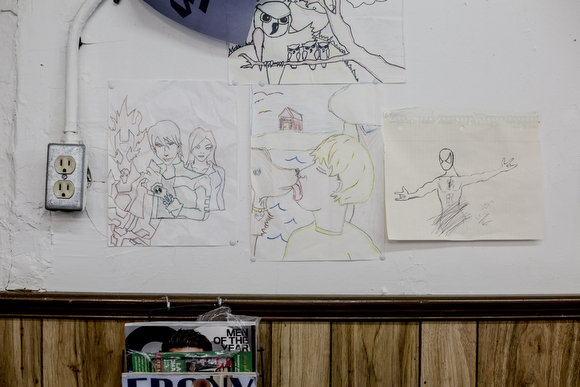 Eric Steward has drawings by his son hanging on many of the walls of the Handy Spot, the barber shop that has been in his family for decades. 