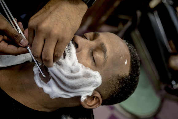  Michael Harris gets a shave from Eric Steward, owner of the Handy Spot on Vollintine Avenue in Klondike. "You can pretty much fall asleep in the chair if you trust your barber," Steward said. 