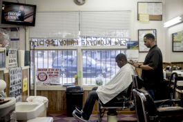 Derek Stubbs gets his hair cut by Eric Steward, the owner of the Handy Spot on Vollintine Avenue in Klondike.
