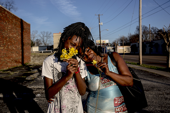 Crystal Shields and her daughter Danielle stand for a portrait after having picked daffodils while walking down Jackson Avenue. The family lives in Klondike.