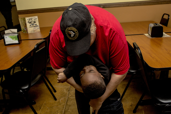 Frankie Walter hugs her grandson Kentrel while taking a break from working at Smoky City Bar-B-Que.
