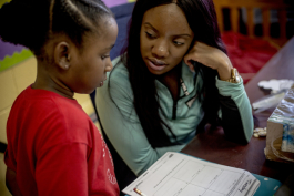 Jasmine Craig helps Alexis Dorse, 7, with her math homework at the John Dustin Buckman Boys & Girls Club’s learning center.