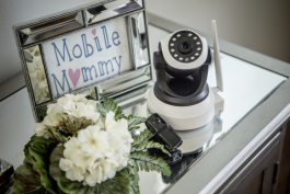 The larger camera serves as a nanny cam that parents can access via an app on their phone. The smaller camera is a body worn camera that babysitters can wear on request of the clients.