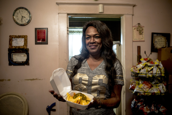 Deidra Tuggle, the Candy Lady of Orange Mound, serves up a nacho plate in her kitchen for her after school customers.