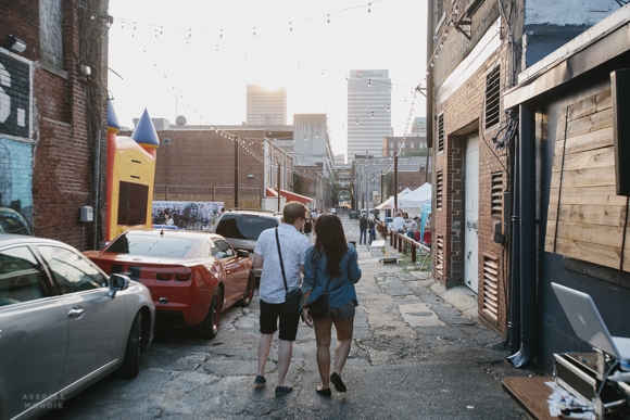 A couple walks down Floyd Alley towards the main stage are the The Edge alley party.