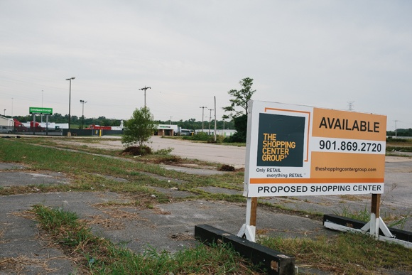 A real estate sign denotes the availability of the Frayser property sits advertising the proposed use of a shopping center.