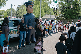 Sergeant Biggs, a Memphis Police Department mascot, greets members of the community outside Cathedral of Faith during the Klondike-Smokey City foster care awareness parade. (Brandon Dahlberg)