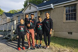 James Cook and his family stand outside the future home of Nubian Design Studios in Whitehaven. The building is currently under renovations with help from an EDGE Inner City Economic Development loan . (Ziggy Mack)