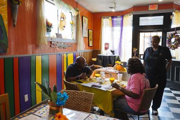 B.J. Chester-Tamayo serves patrons at Alcenia's restaurant in the Pinch District. (Ziggy Mack)