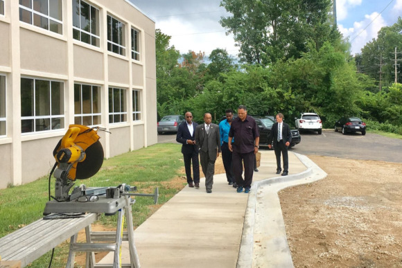 CME Church Bishop Henry Williamson and Rev. Jesse Jackson (front and center) discuss the renovation of the historic hospital.