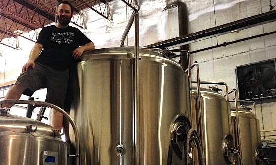 Memphis Made co-owner Drew Barton atop fermenting tanks