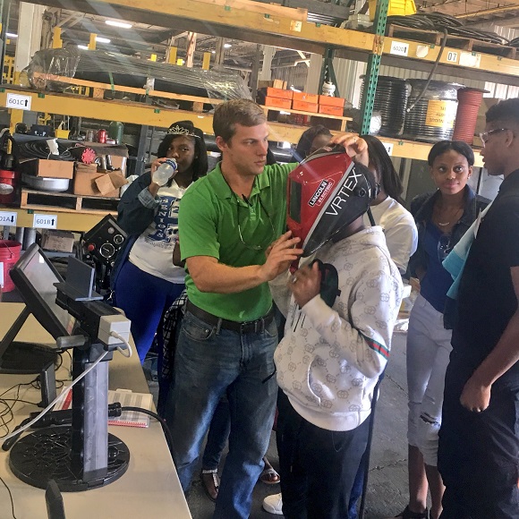 Student from Hamilton High School tries out welding through virtual reality technology at Barnhart Crane for National Manufacturing Day