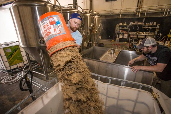 Memphis Made assistant brewer Alex Ball emptying the mash tun