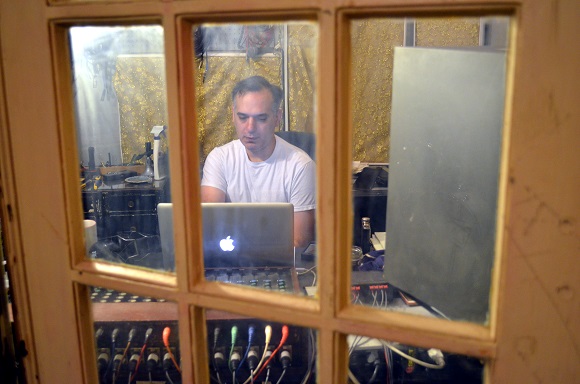 Harry Koniditsiotis works behind the salvaged doors that separate him from the bands recording in the one-room 5 and Dime Recording studio behind his Cooper-Young home