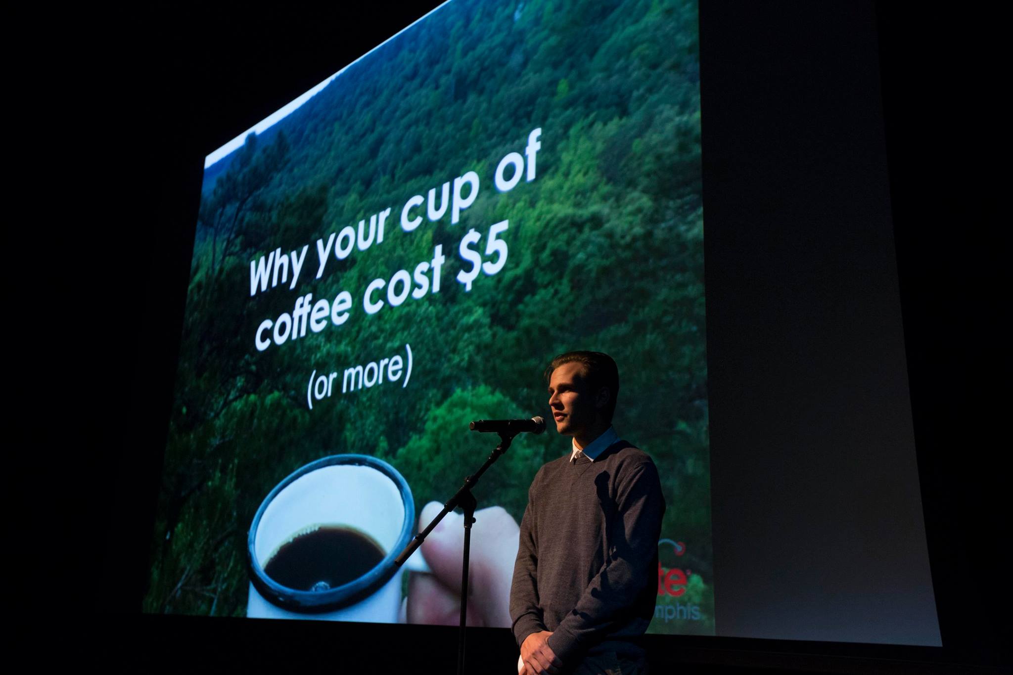 Brendan Larkin at Ignite Memphis, Vol. 9. delivering his talk "Why Your Cup of Coffee Costs $5"