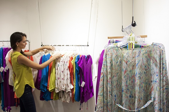 Dilettante Collection designer Tara Skelley offers her clothing for sale during opening night of The Lab’s trunk show