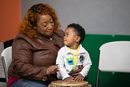 A parent and child make music in a drum circle at the Knowledge Question Universal Parenting Place in South Memphis. (Submitted) 