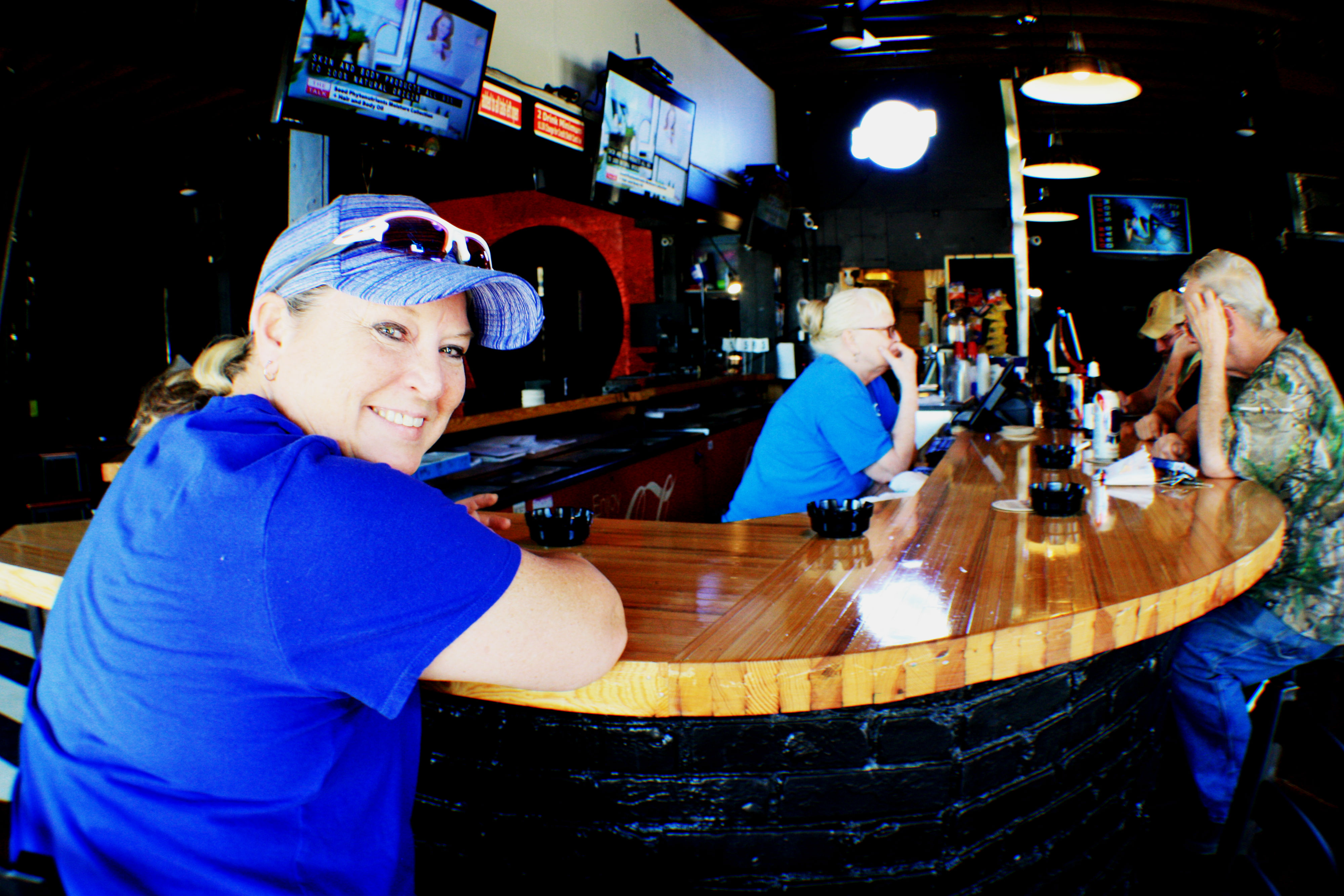 Tami Montgomery, owner of Dru's Bar, sits at the newly remodeled bar and chats with regulars after completing some chores around the business. The location, 1474 Madison Avenue, has been home to a number of LGBT bars since the 1970s. (Cole Bradley)