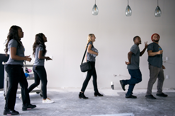 Inspire Community Cafe owner Kristin Fox-Trautman, center, walks with her team, from left, Charlena Branch, Jacqueline Chandler, Tevin Whitley, and Terrance Whitely, inside the restaurant which is currently under construction in Binghampton. (Brandon