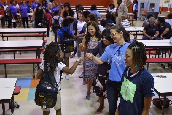 As the students received their backpacks they high-fived and fist-bumped volunteers for the ZIP Code 38126 Back to School Project. 