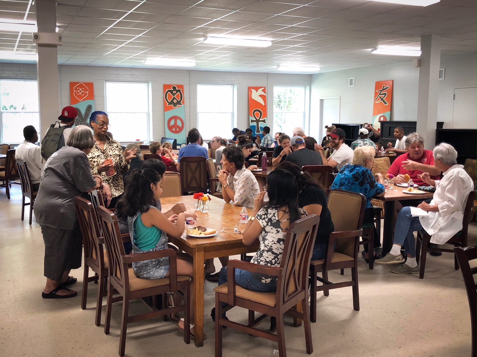 Community members sat down to enjoy hamburgers, hotdogs, and chips in the bright and airy space. (Shelda Edwards) 