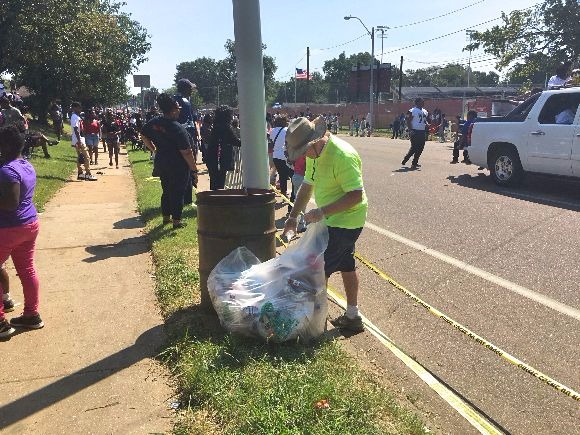 Volunteers pick up trash at the 2017 Orange Mound parade. 