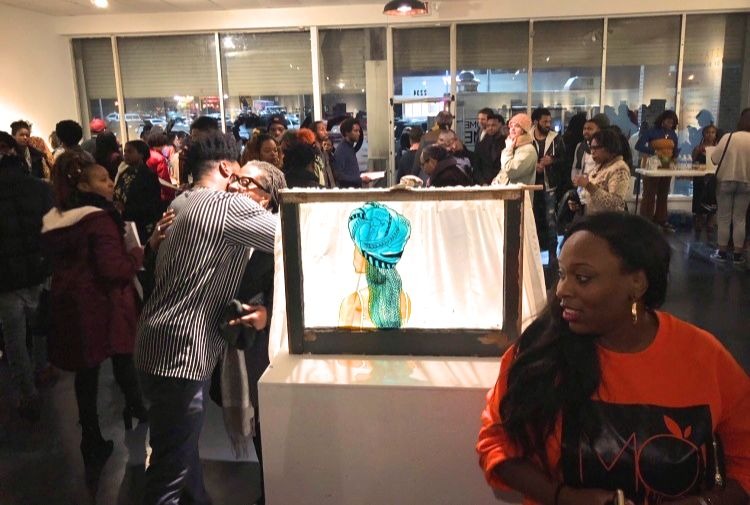 Artists and guests mingle January 11 at the new CMPLX gallery and studio in Orange Mound. In the center of the room stands a piece by artist Felicia Wheeler. (Cole Bradley)