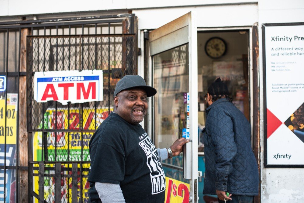 Rufus Sykes cracks a smile as he holds the door open for a customer at the South Memphis Grocery on West Mallory Avenue. Sykes co-owns the corner store with other family members. (Malik Martin)