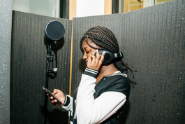 Mickele Bridges collaborates with other students to produce a song in Cloud901's recording studio.
