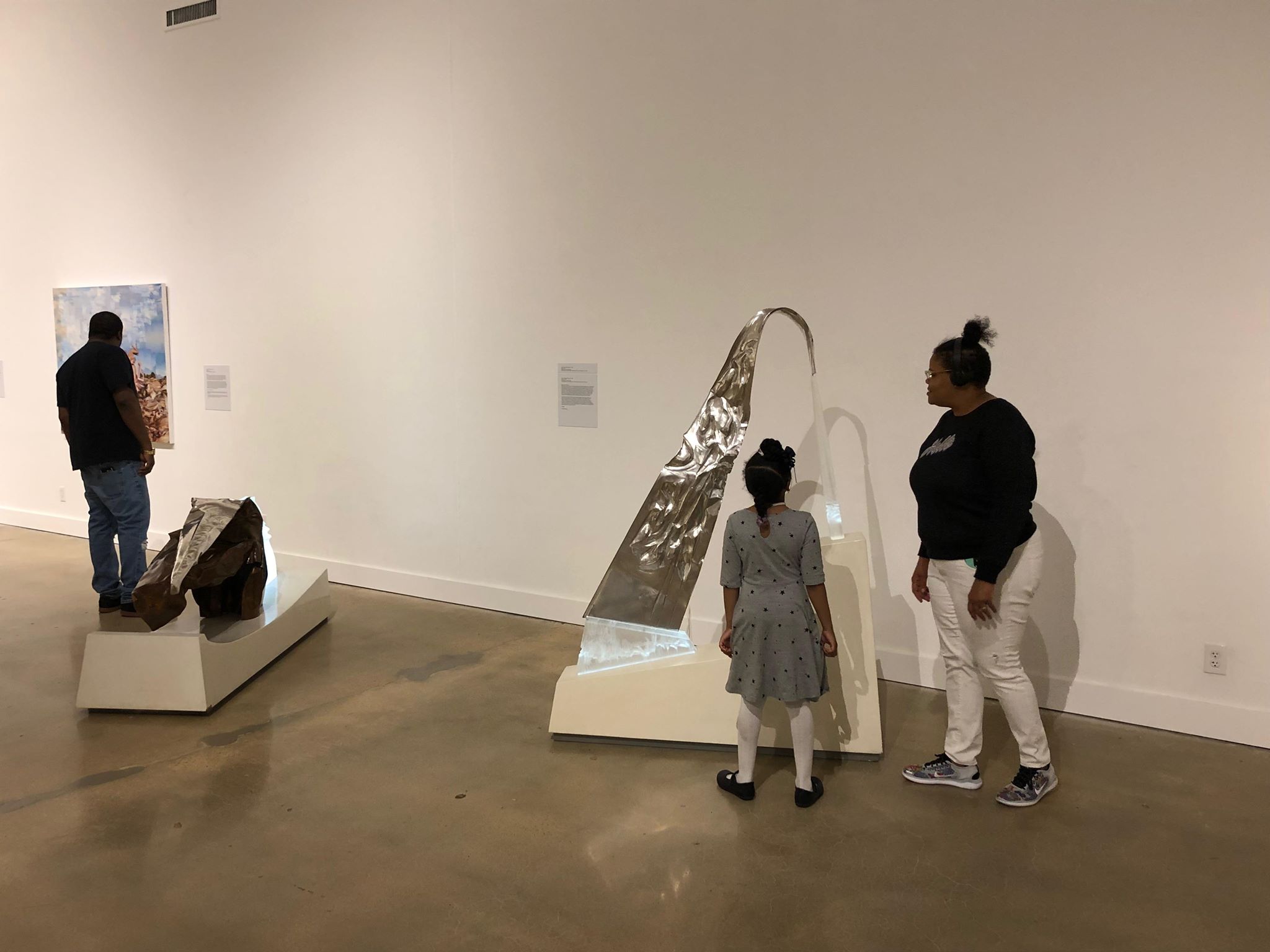 Megan Savare looks on as daughter Christina shares her favorite piece of the “Dear Artist” installation - a sculpture by John Carl Marshall titled “Glacier”. (Scarlet Ponder)