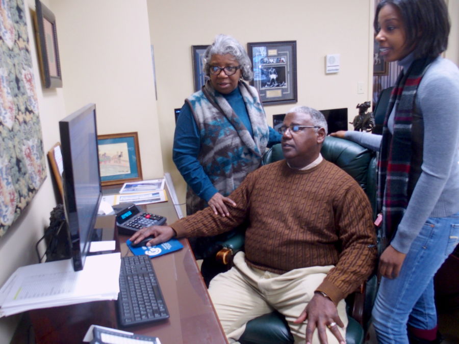 Winston Gipson confers with his wife and daughter, who help run Gipson Mechanical Contractors, a family-owned business in Memphis for 35 years. (Laura Faith Kebede)