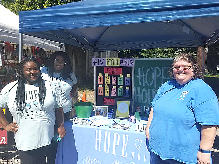 Jessica Cox, far left, works at an outreach booth for HIV awareness in the South City neighborhood in ZIP 38126. (Submitted)