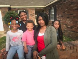 Shamika Williams poses with her four children outside of their home in Raleigh. In fall 2018, Williams fled an abusive relationship and stayed with her kids at the YWCA’s domestic violence shelter. (Cole Bradley)