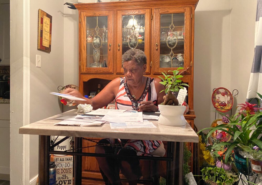 Geraldine Williams sorts through bills at her dining room table. A bus driver for the last 13 years, Williams has been on unemployment since Shelby County Schools closed in March. She receives approximately $247 a week. (Shelia Williams)