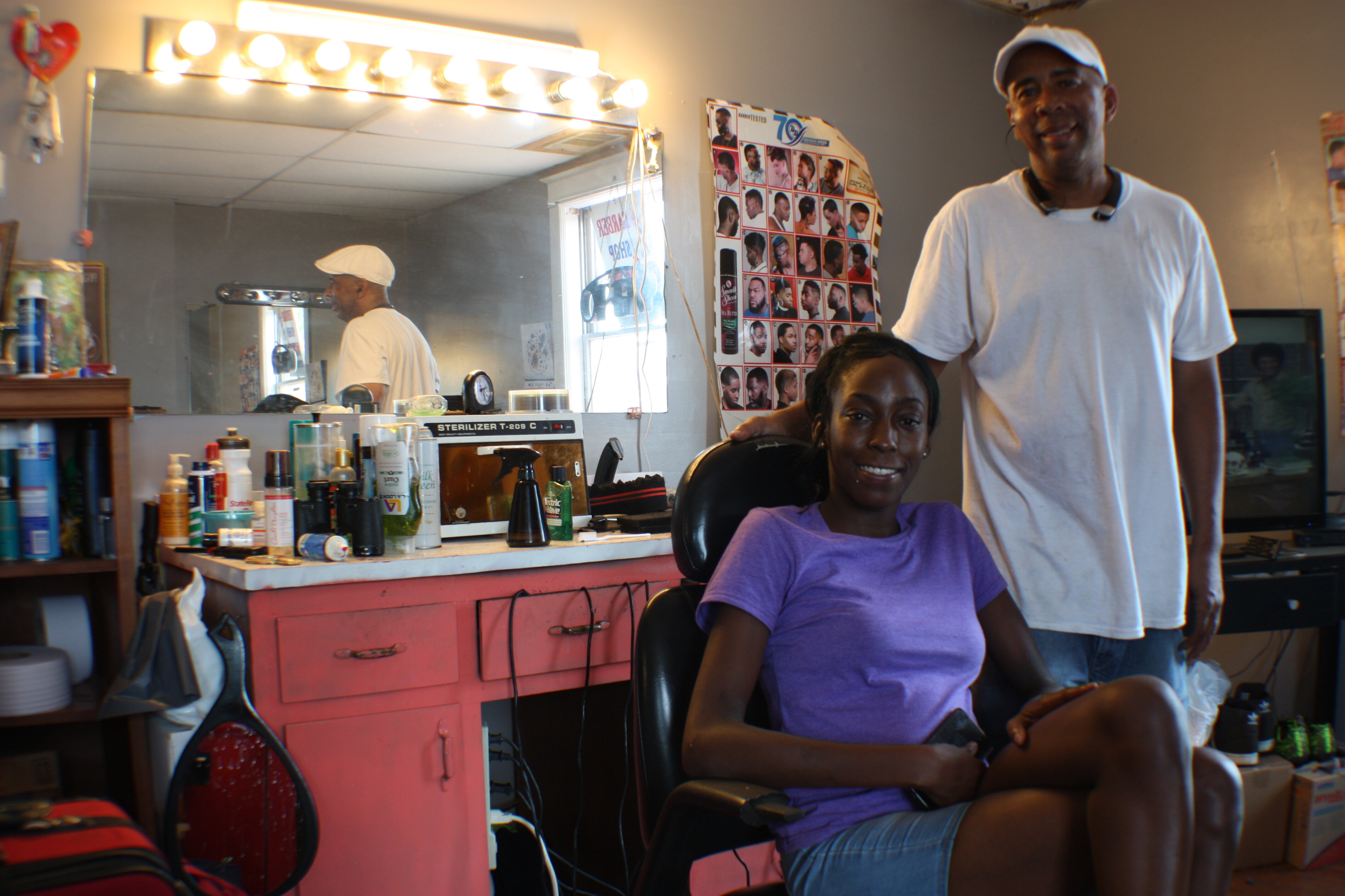 Stylist Erica Ward and master barber and manager Tony Mckissick pose inside Pyramid Famous Cutz. (Cole Bradley)