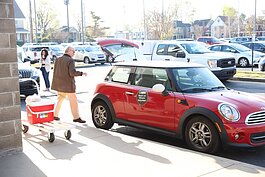Volunteers load up their cars at MIFA headquarters as they prepare for another day’s delivery of Meals on Wheels.