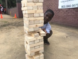 A young South Memphis resident plays with a giant Jenga set. (Shelda Edwards)