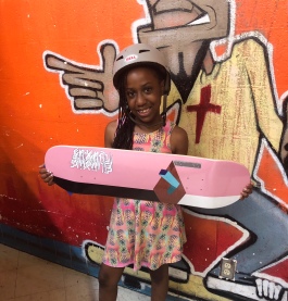 Madison Taper, winner of the girls' ages 8 to 15 division, shows off her new Fluxus skateboard. Fluxus boards are made in Memphis and are designed by local artists. (Shelda Edwards)