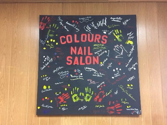 The owner of Colours the Nail Salon calls the interior artwork a "collage of unity". (Sarah Jones)