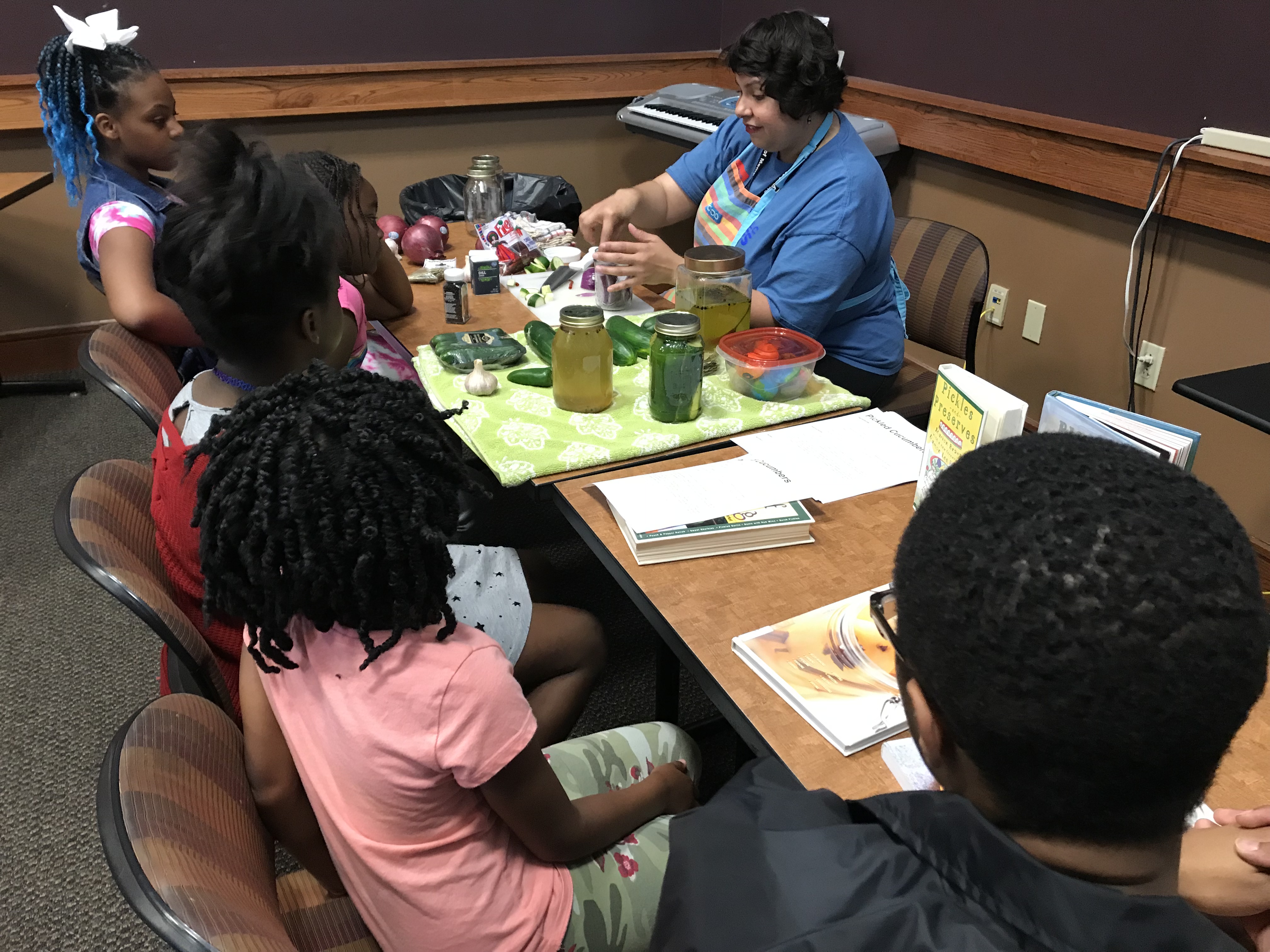 Melissa Sierra, Connect Crew manager for the Memphis Public Library system, talks about the process of making brine for a pickling class at the How-To-Festival, held at the Whitehaven Library on Saturday, April 27. (Kim Coleman)