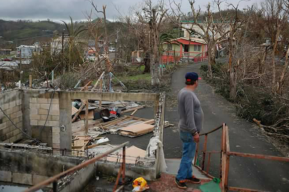 A resident looks on the devastation wrought by Hurricane Maria in Coamo, Puerto Rico.