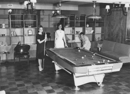 Elizabeth Frey, Marilyn Trigg, and John Maurer of the Dorcas Society of St. Peter's Catholic Church play pool at the underground bomb shelter. (University of Memphis special collections)