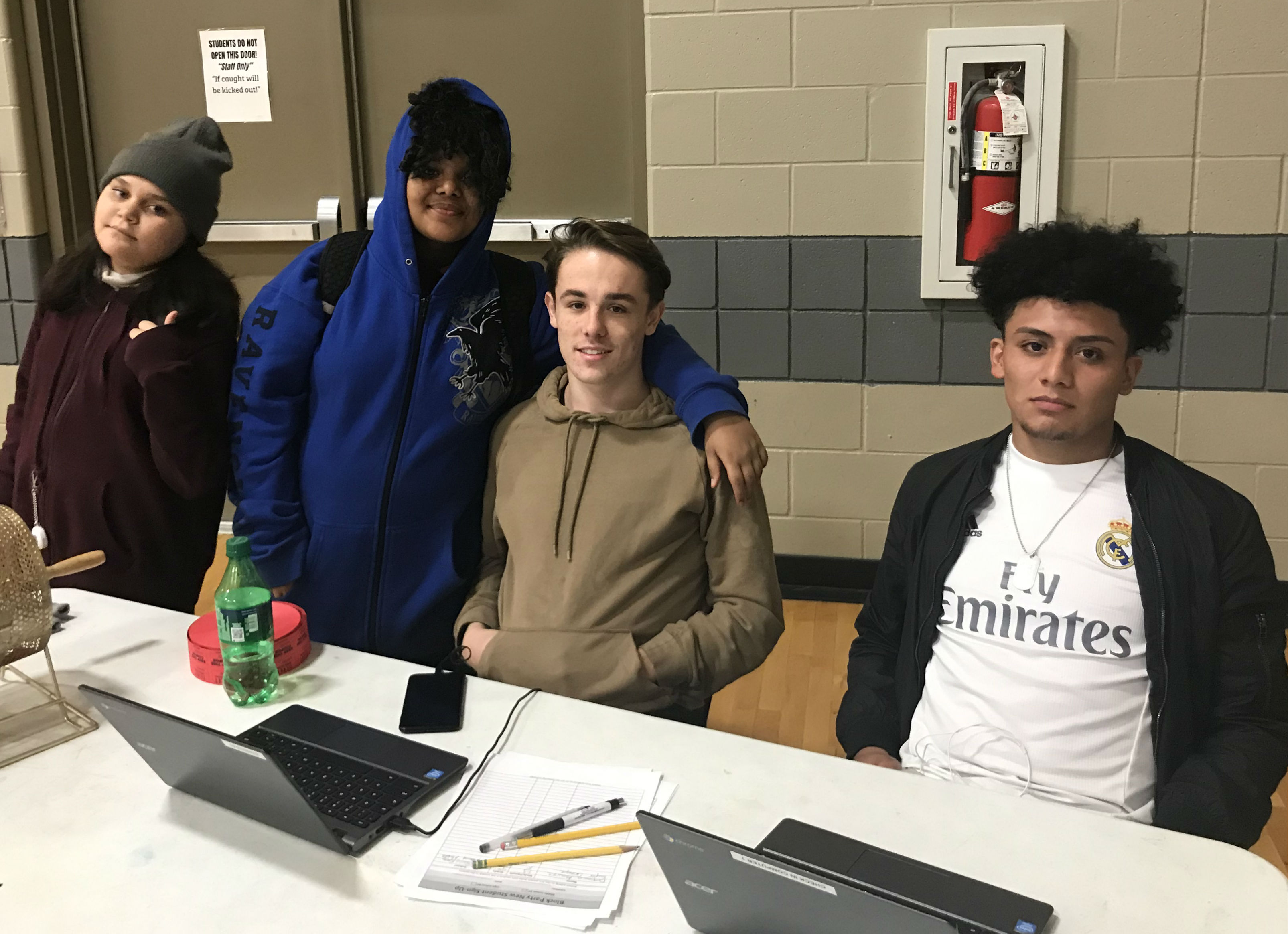 Olivia Ramirez, 11, Kharman Figueroa, 11, Michael Kollatz, 17, and Pedro Duarte, 16, were helping middle school youth sign up for a Nov. 12 block party at The Heights campus of STREETS Ministries.