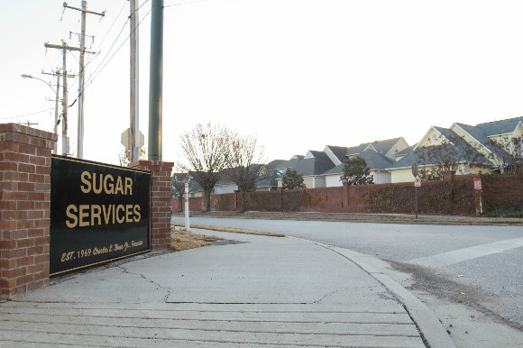 Sugar Services, an active industrial site, faces a dense residential community.