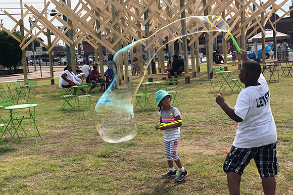 Neighborhood children played games and made giant bubbles at the June 2nd kickoff event.